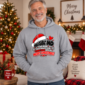 Man wearing a cozy Husband holiday hoodie with festive “Makes Our Christmas Merry & Bright” typography.