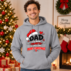 Man wearing a festive Dad Christmas hoodie featuring “The Man, The Myth, The Bad Jokes” typography with Santa hat artwork.