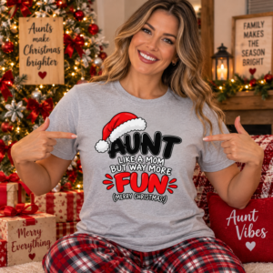 Woman wearing a festive Aunt Christmas T-shirt with “Like a Mom But Way More Fun” typography and Santa hat artwork.