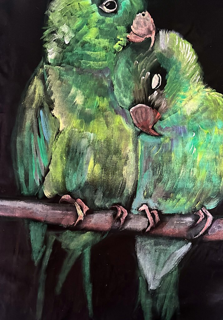 First color layer of two parrots painted by hand on black fabric