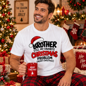 Man wearing a Brother holiday T-shirt with humorous “Still My Favorite Christmas Problem” typography in red, black and white.