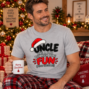 Man wearing an Uncle holiday T-shirt with humorous “Like a Dad But Way More Fun” Christmas typography in red, black and white.