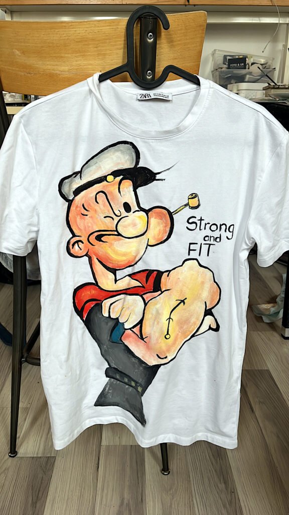 Hand-painted Popeye the Sailor Man character on white fabric