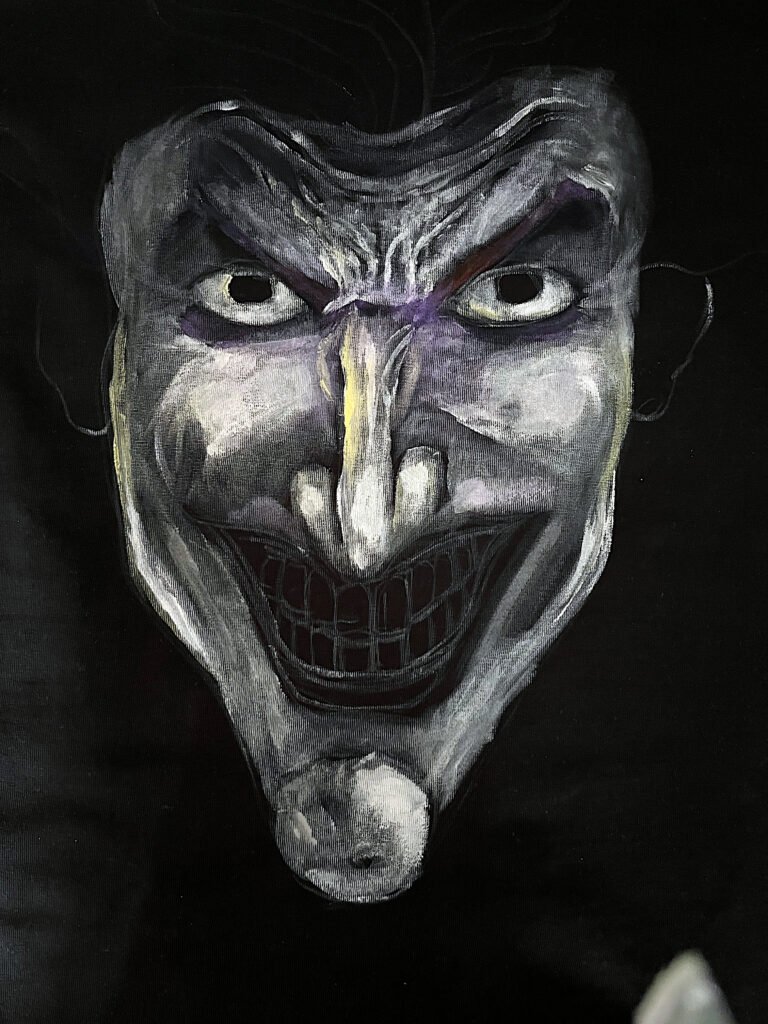 Hand-painted black T-shirt with first layers of white paint added to the portrait